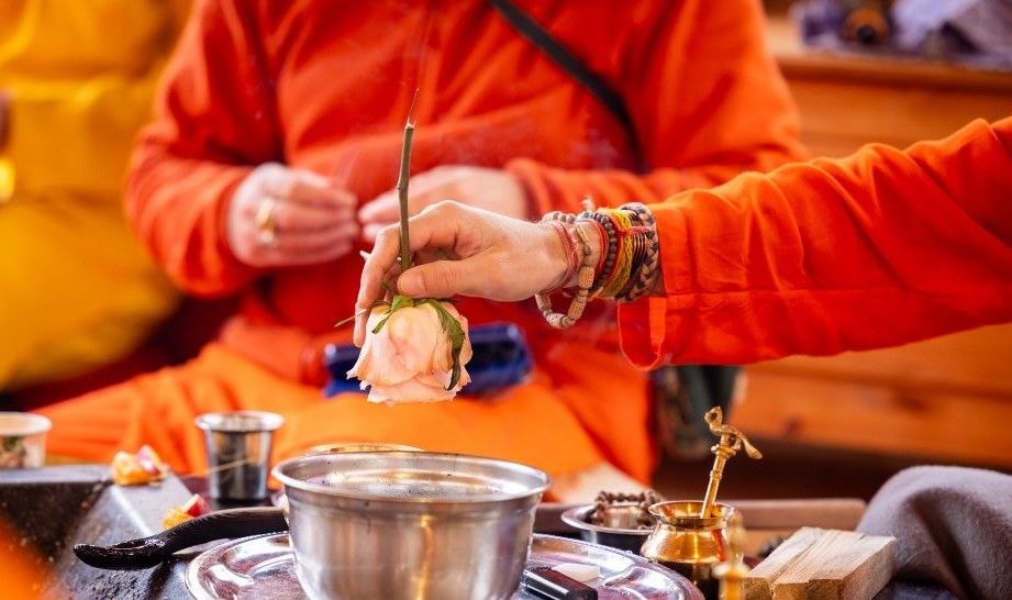 Hands with flower offering at fire