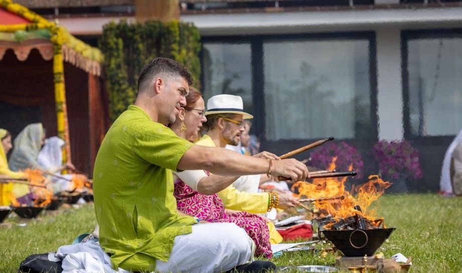 Swamis performing yajna indoors
